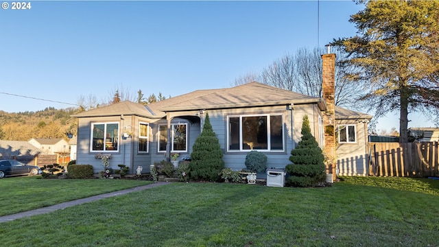 bungalow-style home with a front lawn