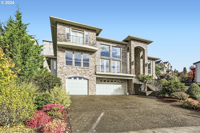 view of front of property featuring a balcony and a garage