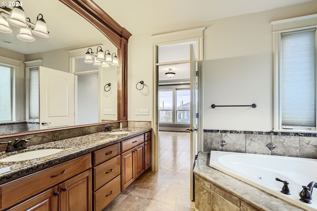 bathroom with vanity, tile patterned floors, and tiled tub