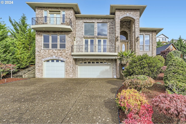 view of front of house with a garage and a balcony