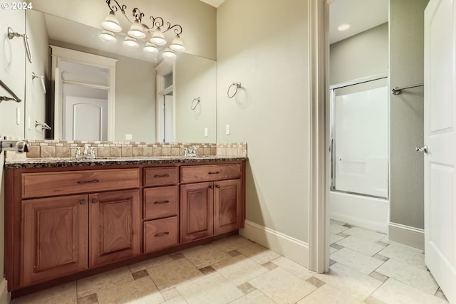 bathroom featuring vanity and shower / bath combination with glass door