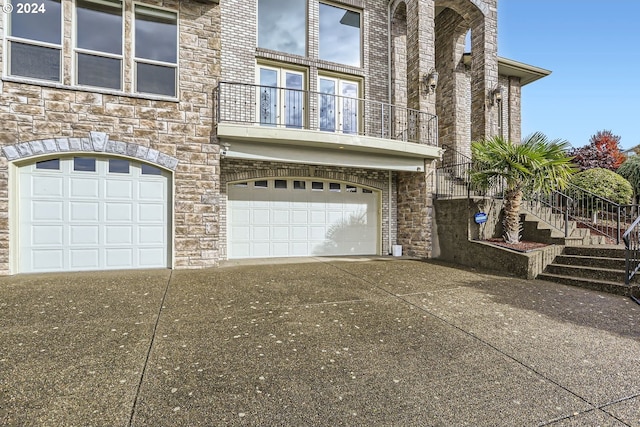 view of front of house with a garage and a balcony