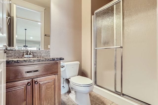 14815 SE Donley Ln, Happy Valley, OR 97086 - full bathroom with a stall shower, toilet, vanity, tile patterned flooring, and backsplash