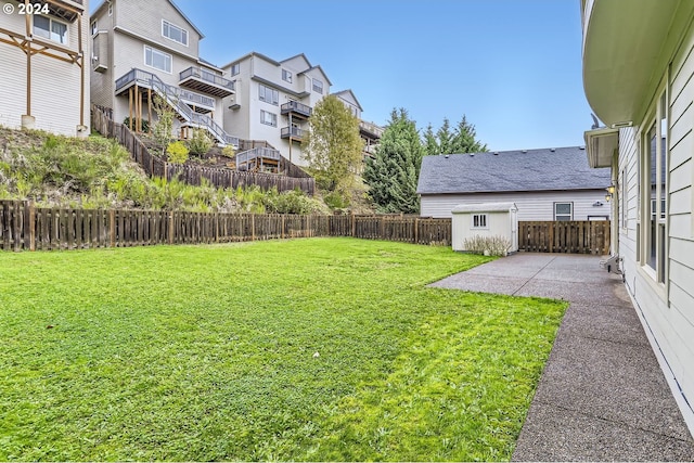 view of yard with an outbuilding and a patio area