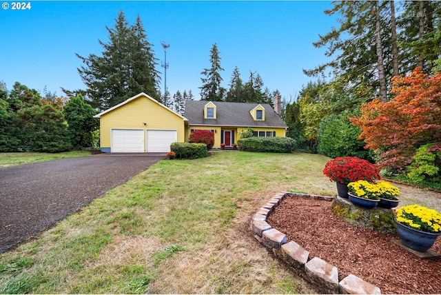 cape cod home with a garage and a front lawn