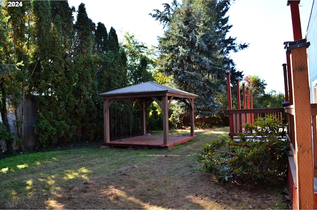 view of yard featuring a wooden deck and a gazebo