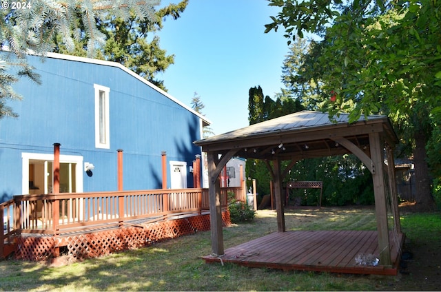 view of yard featuring a wooden deck and a gazebo