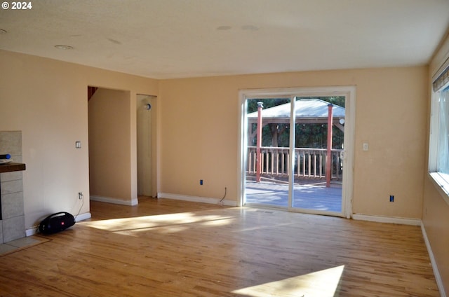 unfurnished living room featuring light wood-type flooring and a fireplace