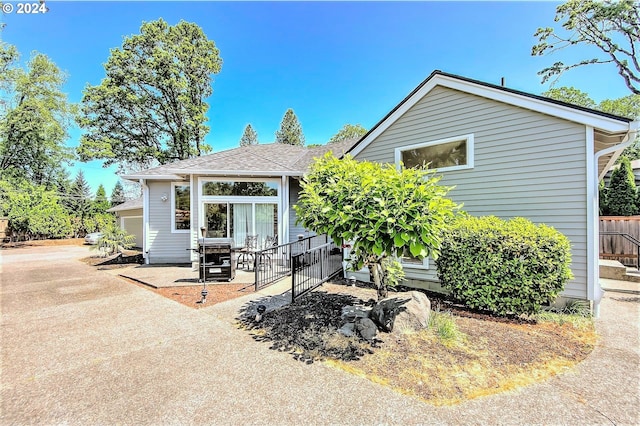 exterior space featuring driveway and fence