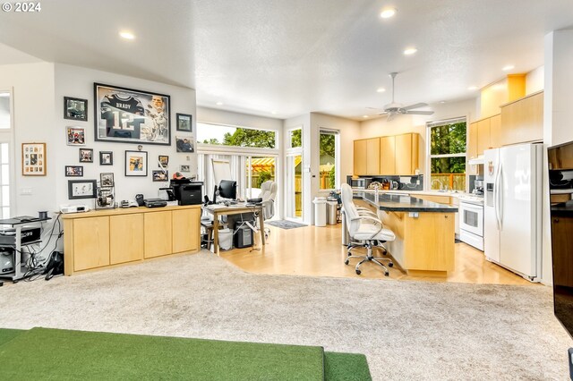 carpeted office with ceiling fan and golf simulator