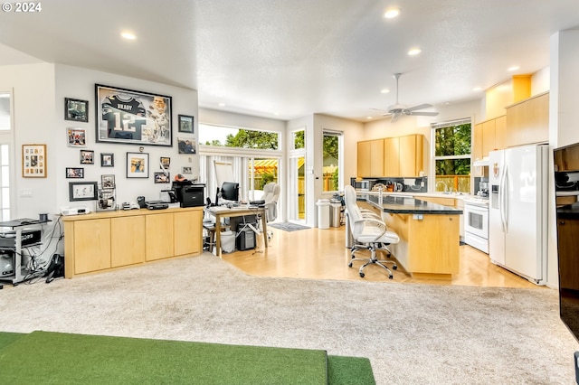 kitchen with light brown cabinets, white appliances, a center island, modern cabinets, and a kitchen bar