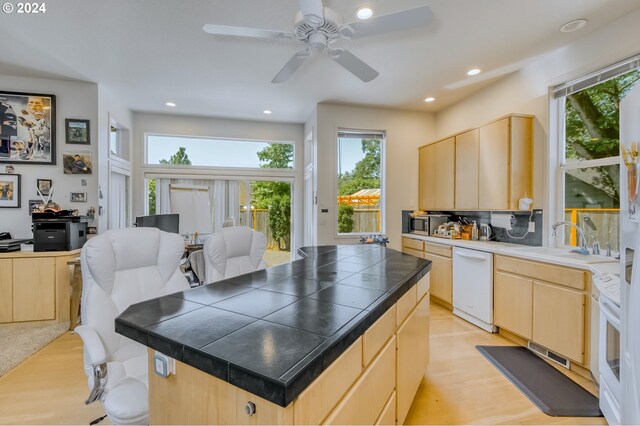 kitchen with light brown cabinets, backsplash, light hardwood / wood-style flooring, ceiling fan, and white fridge with ice dispenser