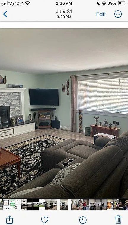 living room with wood-type flooring and a fireplace