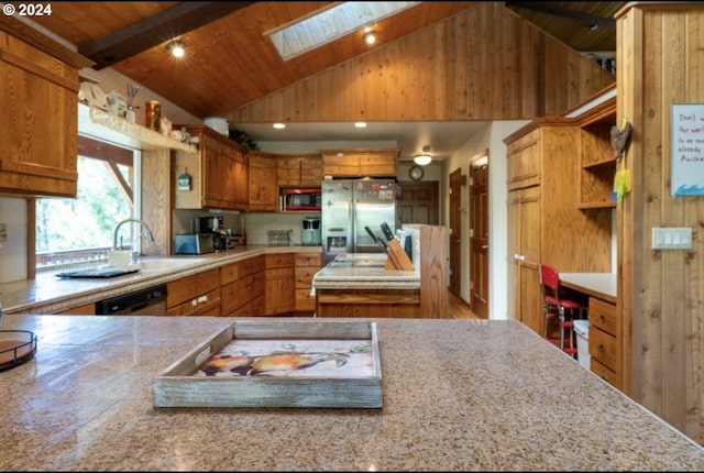 kitchen with high vaulted ceiling, wooden ceiling, appliances with stainless steel finishes, beam ceiling, and a skylight