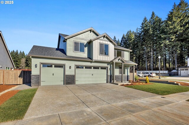 craftsman house with a garage and a front yard