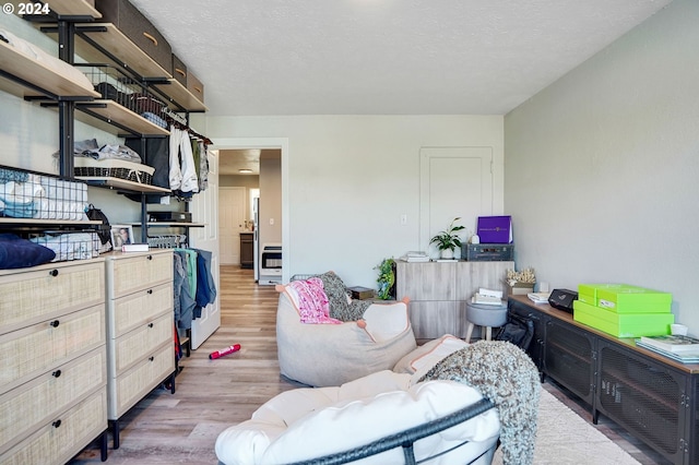 bedroom featuring a textured ceiling and hardwood / wood-style floors