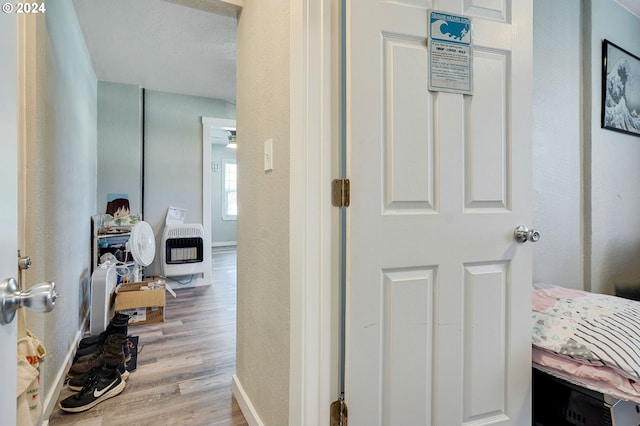 corridor with light hardwood / wood-style flooring