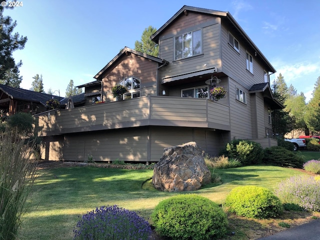 exterior space featuring a balcony and a lawn