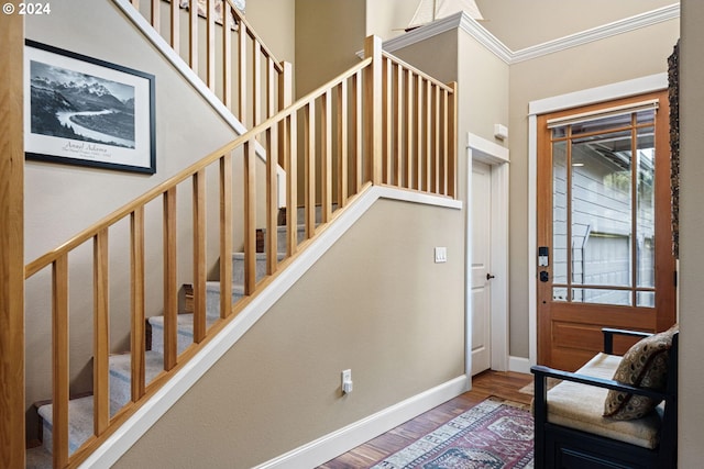 foyer entrance featuring hardwood / wood-style flooring and ornamental molding