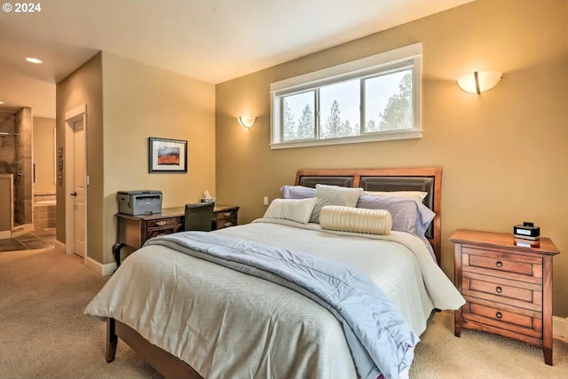 carpeted bedroom featuring ensuite bath