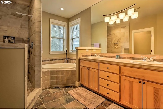 bathroom featuring vanity and plus walk in shower