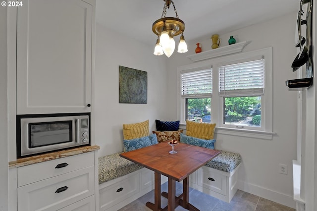 interior space featuring breakfast area, a chandelier, and light tile patterned floors