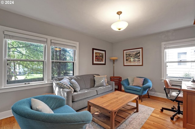 living room featuring light wood-type flooring and baseboards