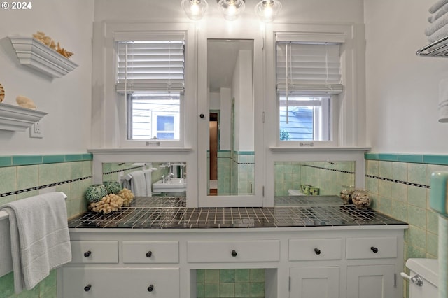 interior space featuring wainscoting and tile walls