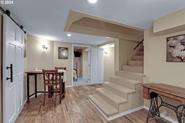 interior space featuring a barn door and light hardwood / wood-style flooring