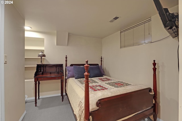 carpeted bedroom featuring baseboards and visible vents