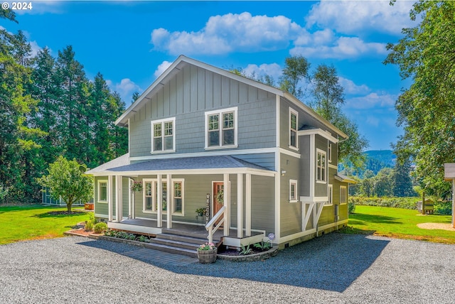 back of property with a yard and a porch