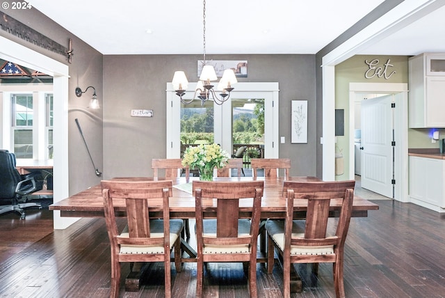 dining room featuring a chandelier and dark hardwood / wood-style floors