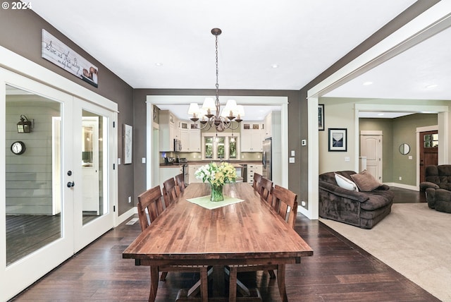 dining area with french doors, a notable chandelier, and dark hardwood / wood-style floors