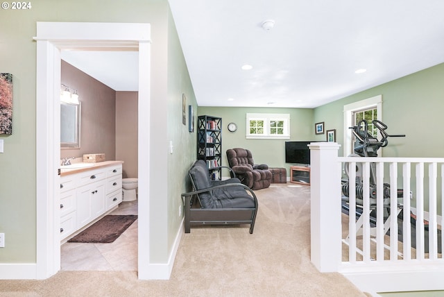 carpeted bedroom with sink and multiple windows