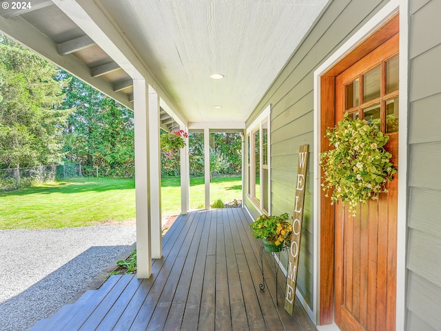 wooden deck with a lawn