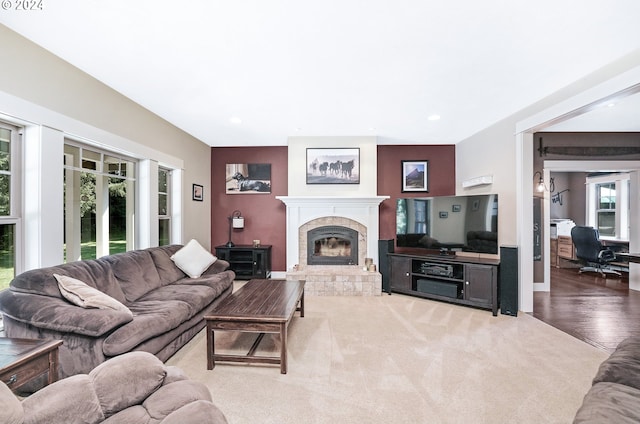 living room with hardwood / wood-style floors and a tile fireplace