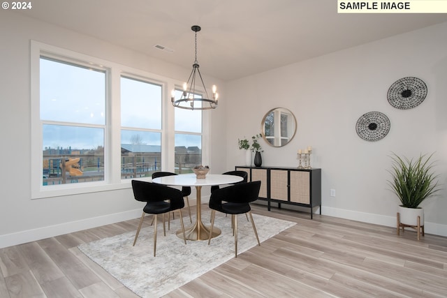 dining room featuring a notable chandelier and light wood-type flooring