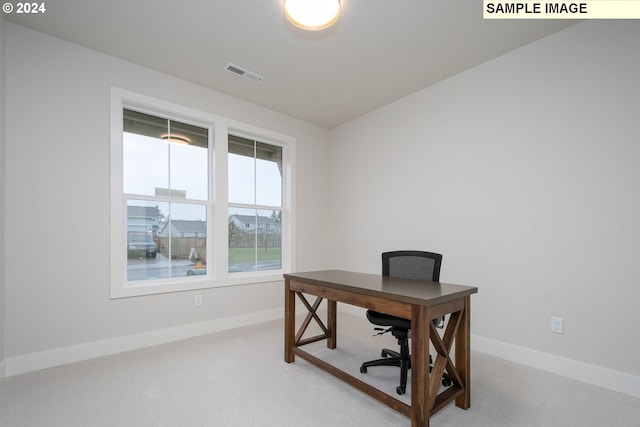 carpeted office space featuring visible vents and baseboards