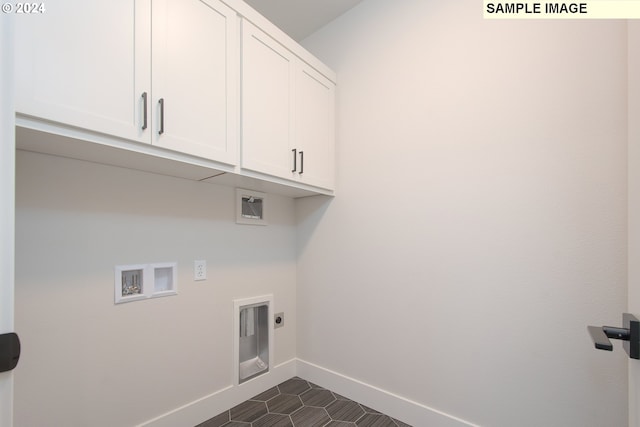 clothes washing area with hookup for a washing machine, cabinets, dark tile patterned floors, and hookup for an electric dryer