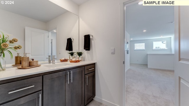 bathroom with vanity and baseboards