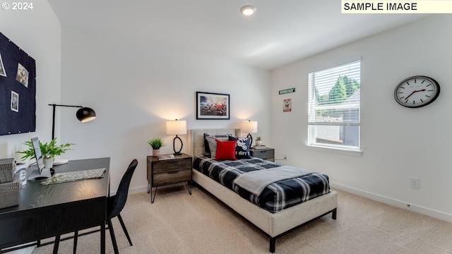 bedroom featuring baseboards and light colored carpet