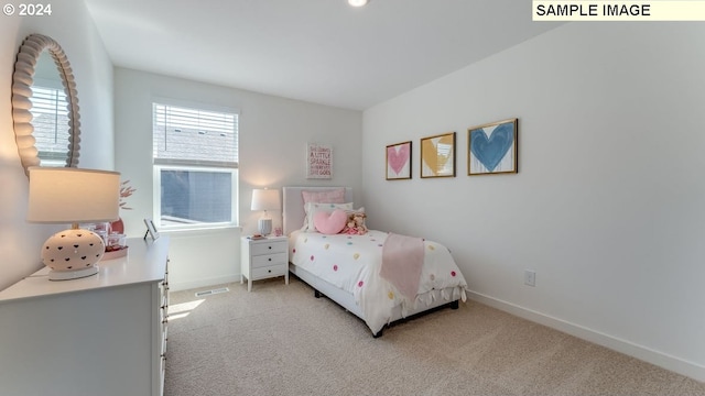 bedroom with light colored carpet, visible vents, and baseboards