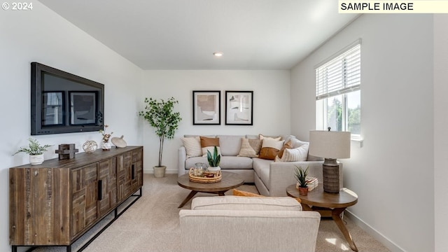 living room with baseboards and light colored carpet