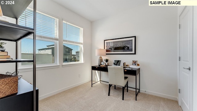 home office featuring light carpet and baseboards