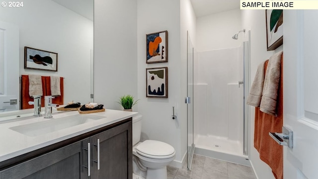 full bathroom with toilet, a shower stall, vanity, and tile patterned floors