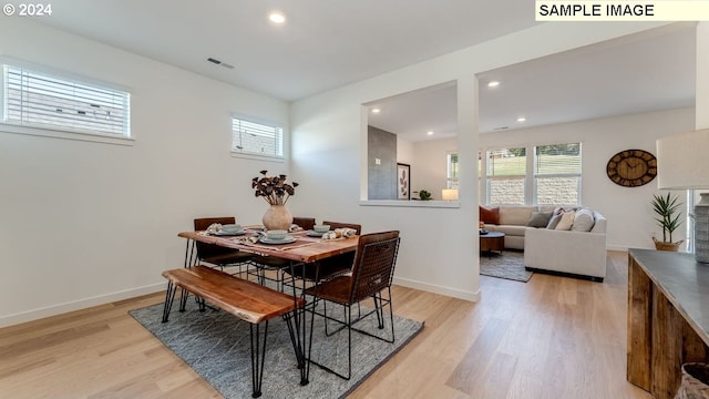 dining space featuring light wood-style floors, recessed lighting, visible vents, and baseboards