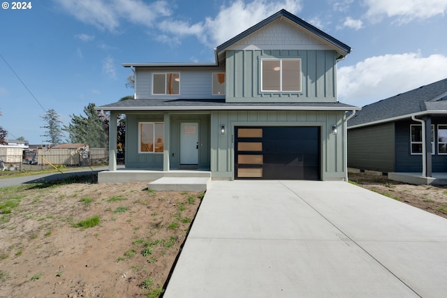 view of front of house featuring a garage and a porch