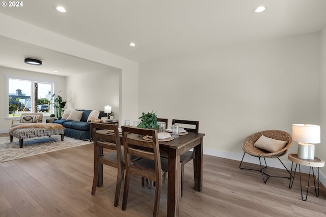 dining space with light hardwood / wood-style flooring