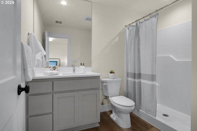 bathroom featuring toilet, hardwood / wood-style flooring, vanity, and a shower with shower curtain