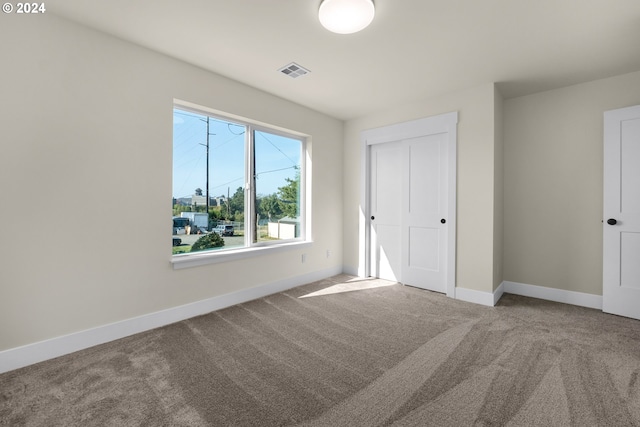 unfurnished bedroom with a closet and carpet